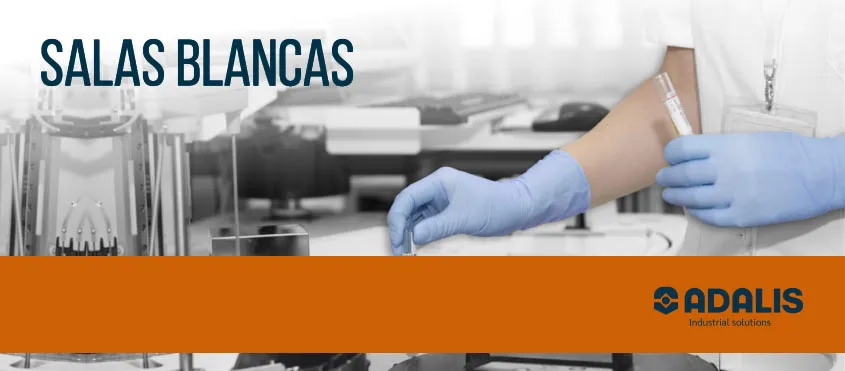 Gloved hands handling test tube in cleanroom lab environment