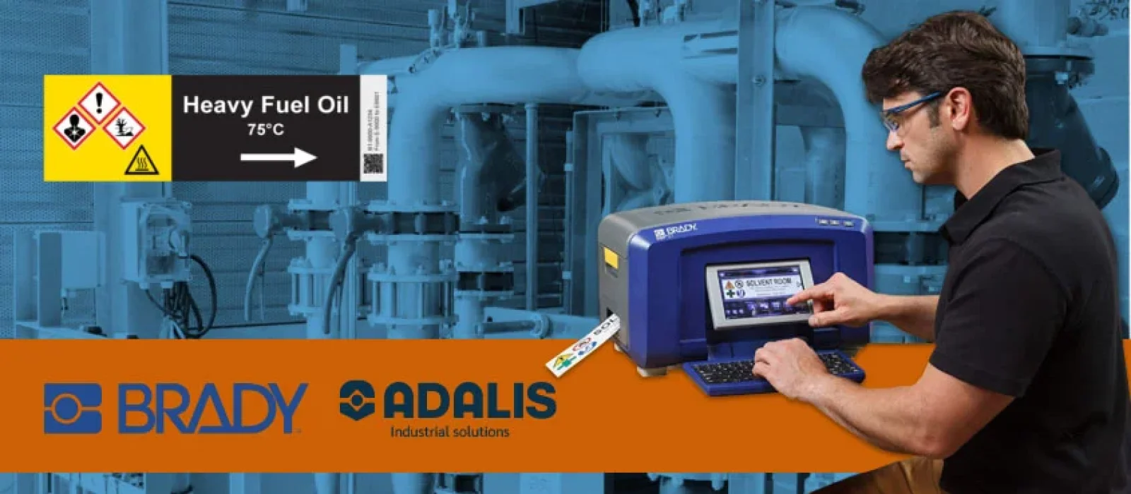 Man using Brady industrial label printer to create chemical safety labels in a mechanical facility