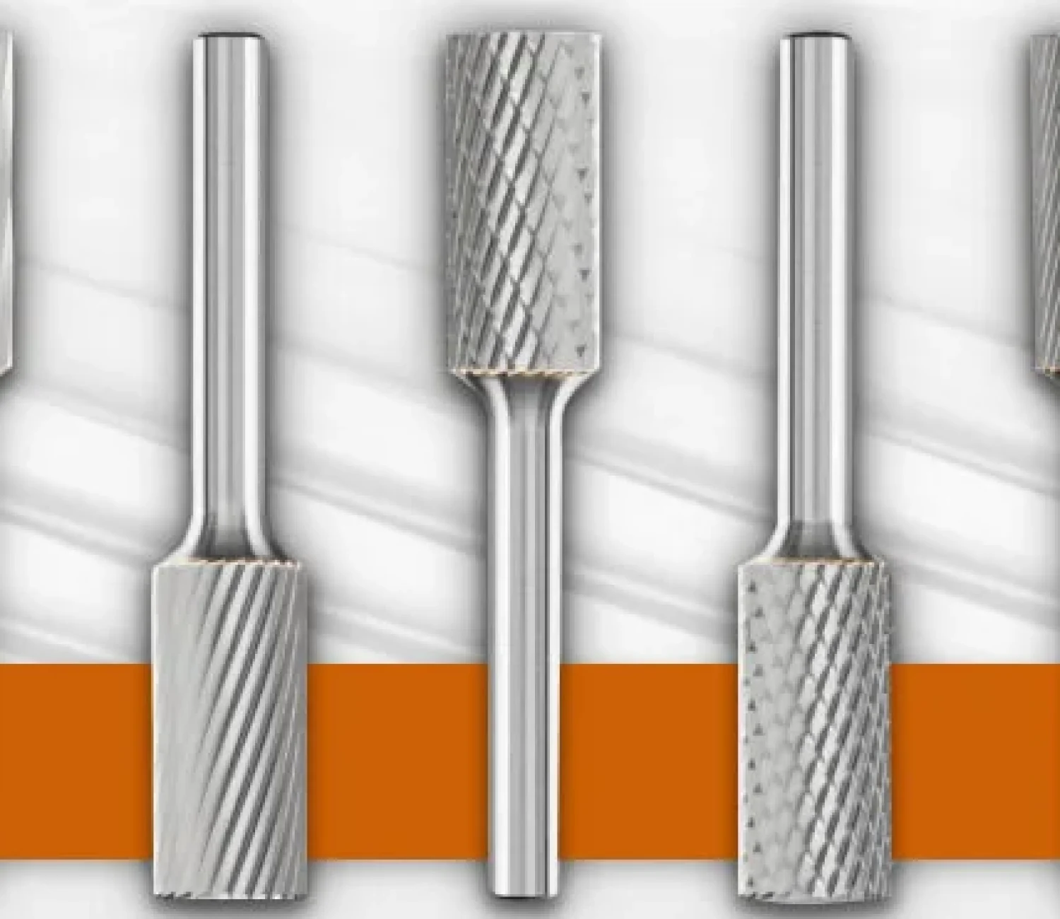 Set of five cylindrical rotary burrs with varied cutting patterns, displayed on a branded Adalis and Pferd background.